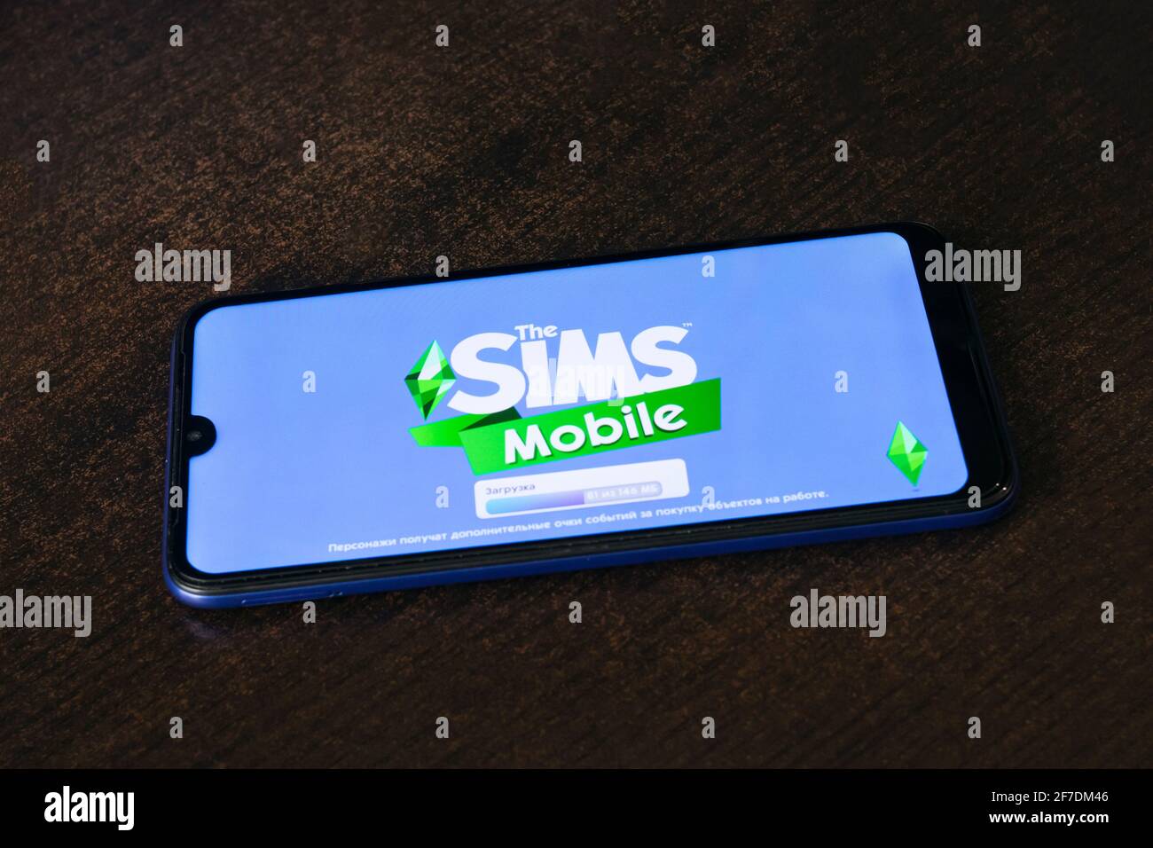 NOVOPOLOTSK, BELARUS - 06 FEBRUARY, 2021: Phone in hand and game Sims on display close up Stock Photo