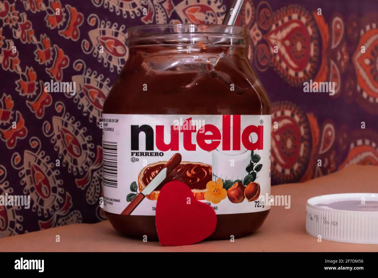 Toronto, Ontario, Canada - February 4 2021: A jar of Nutella, a hazel nut spread, in front of a mandala tapestry. February 5 is World Nutella Day. Stock Photo