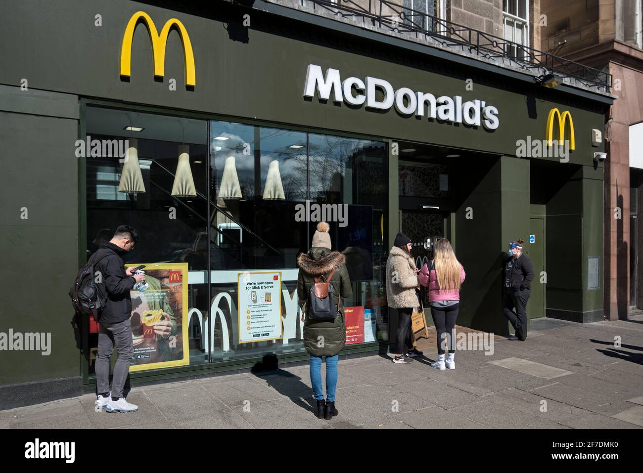 Customers queueing for a takeaway outside McDonald's on Princes Street, Edinburgh, Scotland, UK. Stock Photo