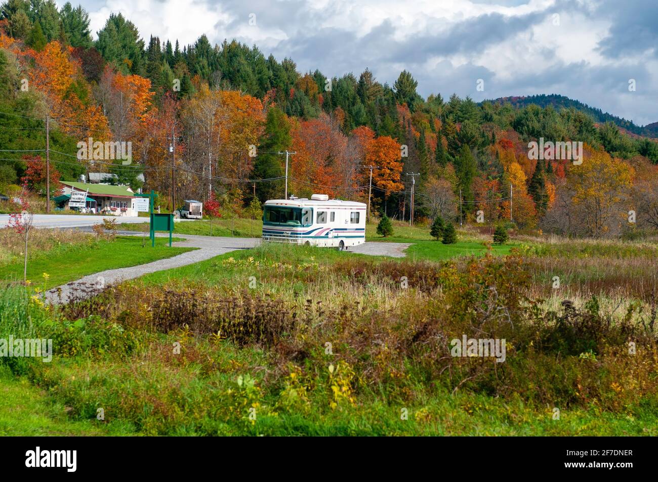 Parking area with class A older RV camper van motor home, Plainfield Village, near  Marshfield, Vermont, USA during an Autumn foliage vacation. Stock Photo