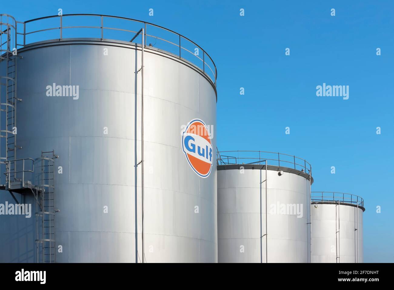 Oil storage tanks with a Gulf logo. Gulf Oil is an American oil company operating gas stations and refined petroleum terminals in Europe and the USA. Stock Photo