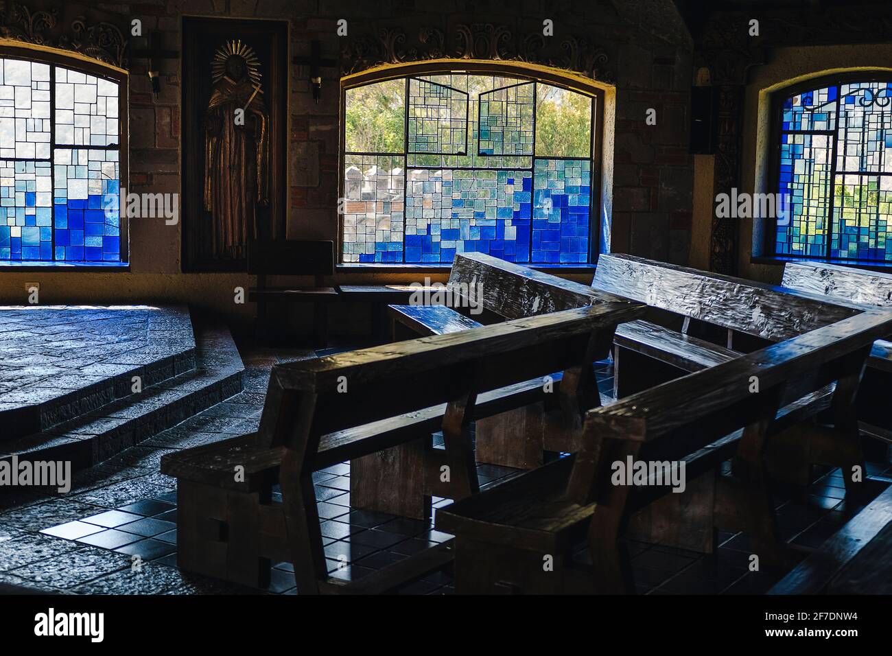 Mexico, Valle de Bravo March 26, 2021, view of the maera benches and a stained glass window in the background inside the chapel of the 'Casa De Oració Stock Photo