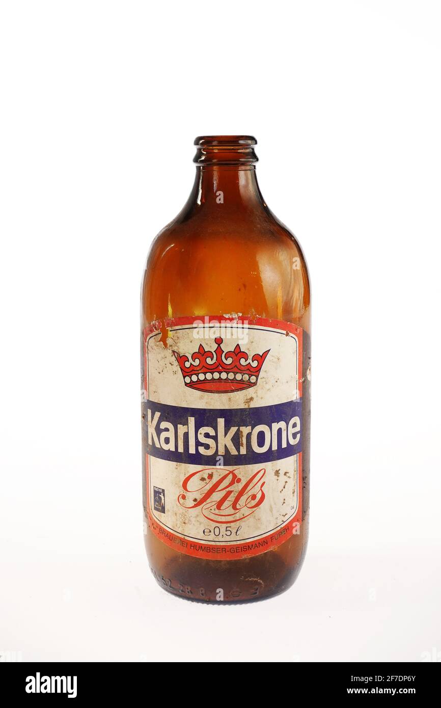 Old empty Karlskrone Pils beer bottle Stock Photo