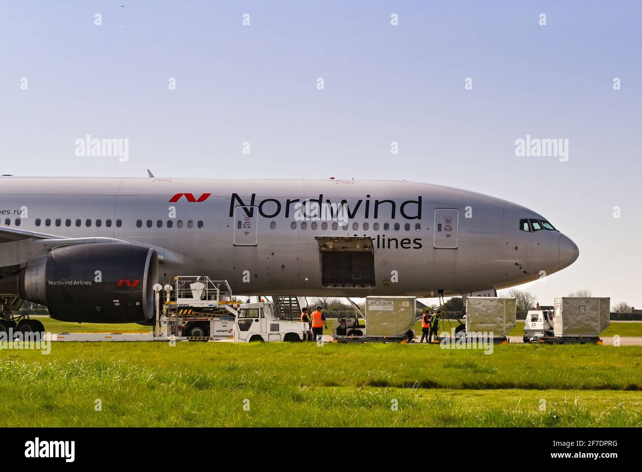 Cardiff, Wales - March 2021: Boeing 777 of Nordwind Airlines (registraion VP-BJJ) with pallet loader and air freight pallets being unloaded at Cardiff Stock Photo