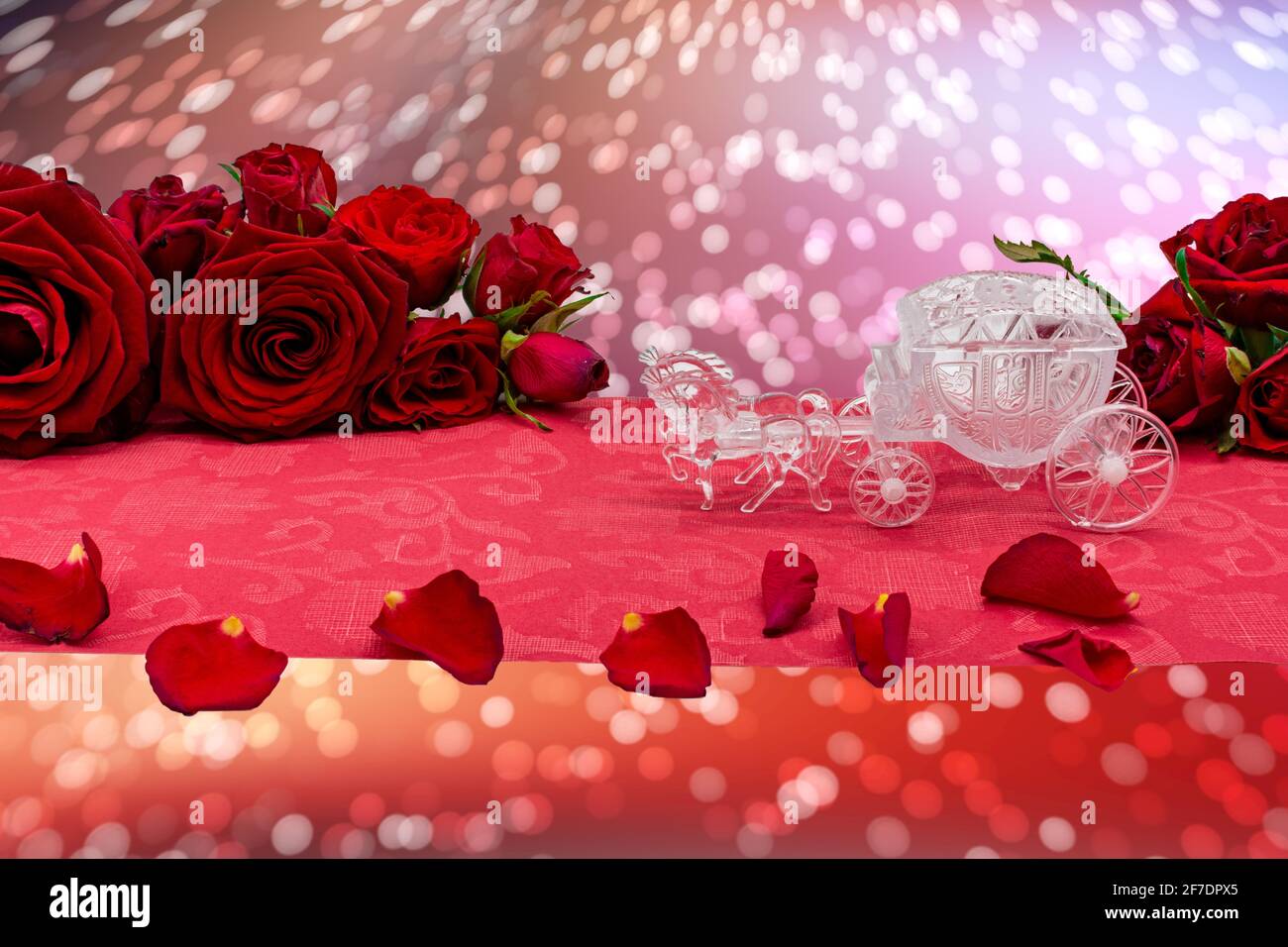 Model wedding carriage rides the red carpet between roses. Template for wedding, engagement and declaration of love, wedding anniversary posters. Stock Photo