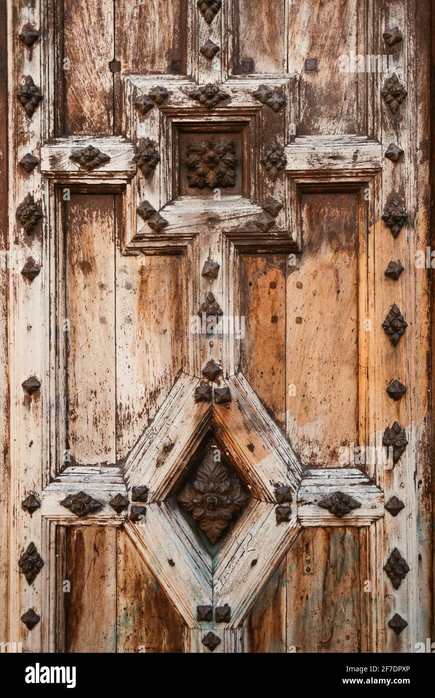 Old wooden door decorated with metal ornaments Stock Photo