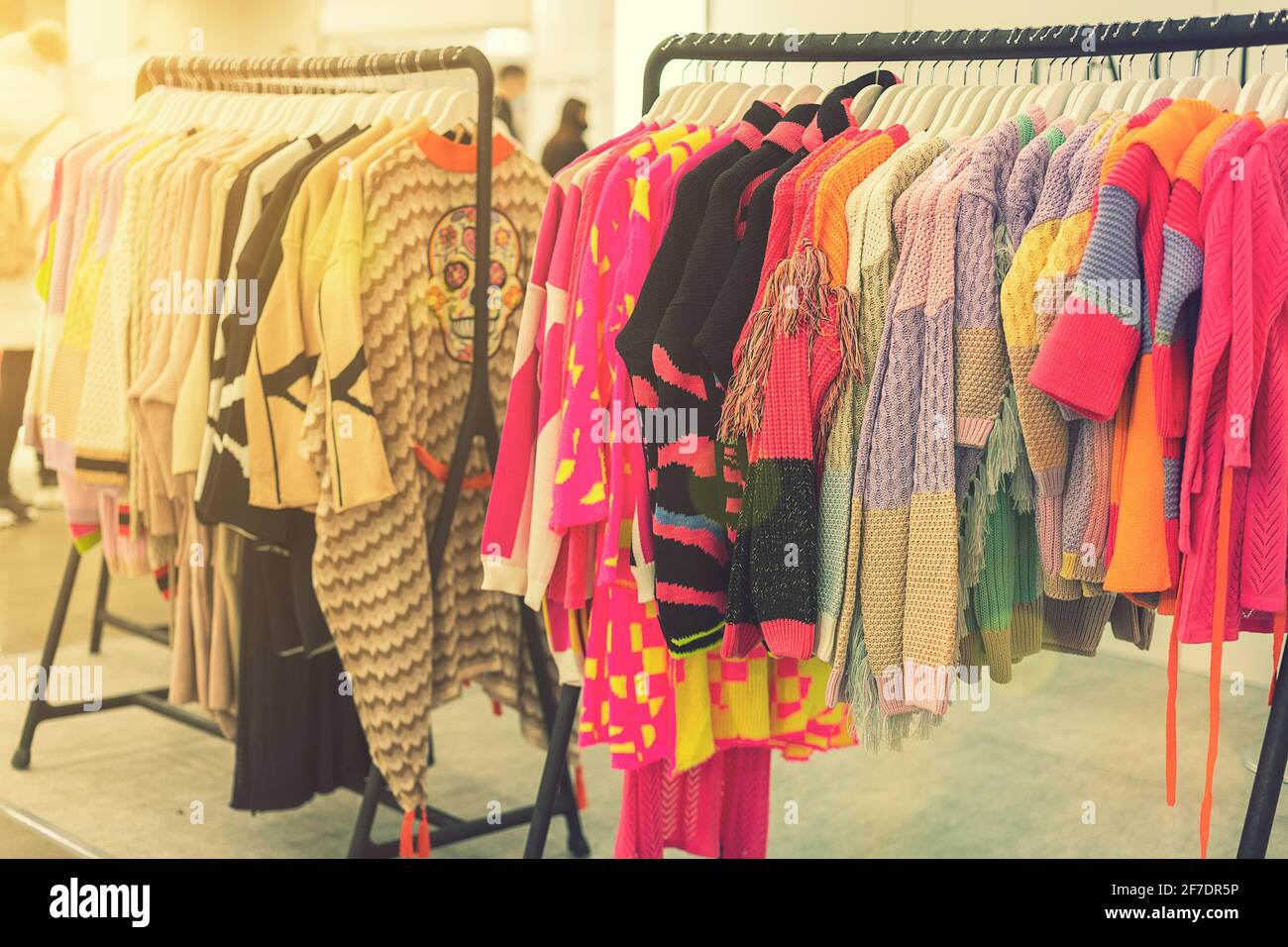spring and summer women's clothing in the store. bright, modern clothes in a boutique. Women's hip clothing store interior concept. concept of choice Stock Photo