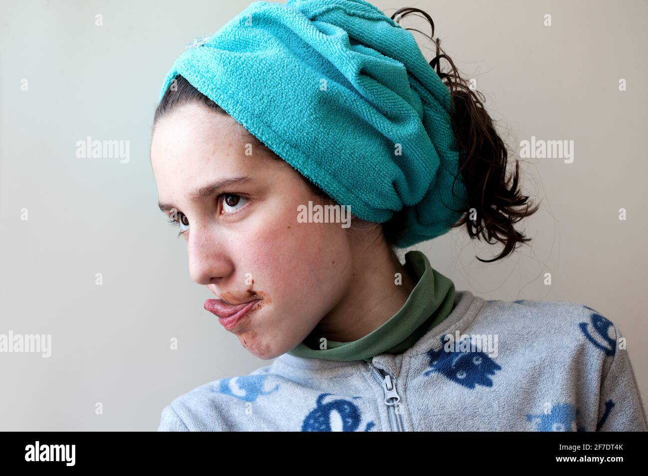 12 year-old boy licking chocolate off his lips. Stock Photo