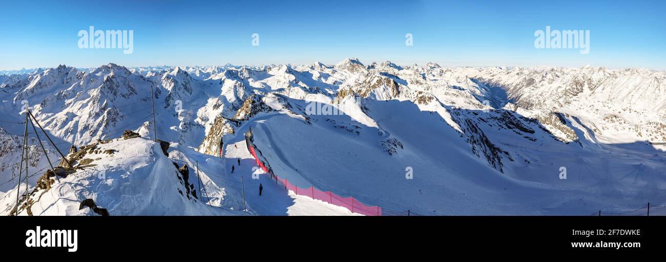 View from Pitztal glacier into the high alpine mountain landscape with cable car station and ski slope in winter with lots of snow and ice, Austrian A Stock Photo