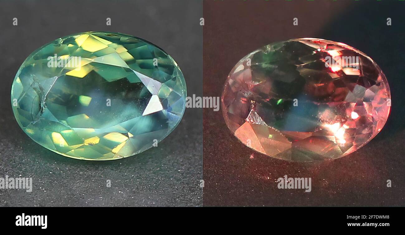 Natural gemstone alexandrite with color change on gray background Stock Photo