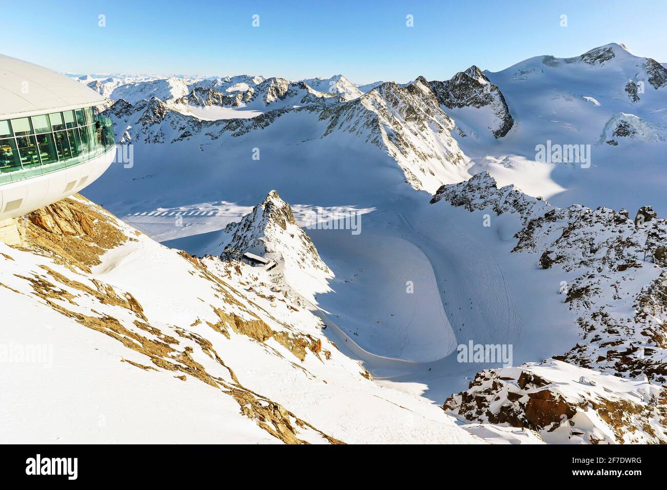 View from Pitztal glacier into the high alpine mountain landscape with cable car station and ski slope in winter with lots of snow and ice, Austrian A Stock Photo