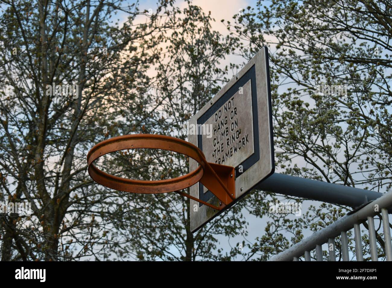 Baseball hoop with the notice: 'Do not hang or climb on the ring'. Stock Photo