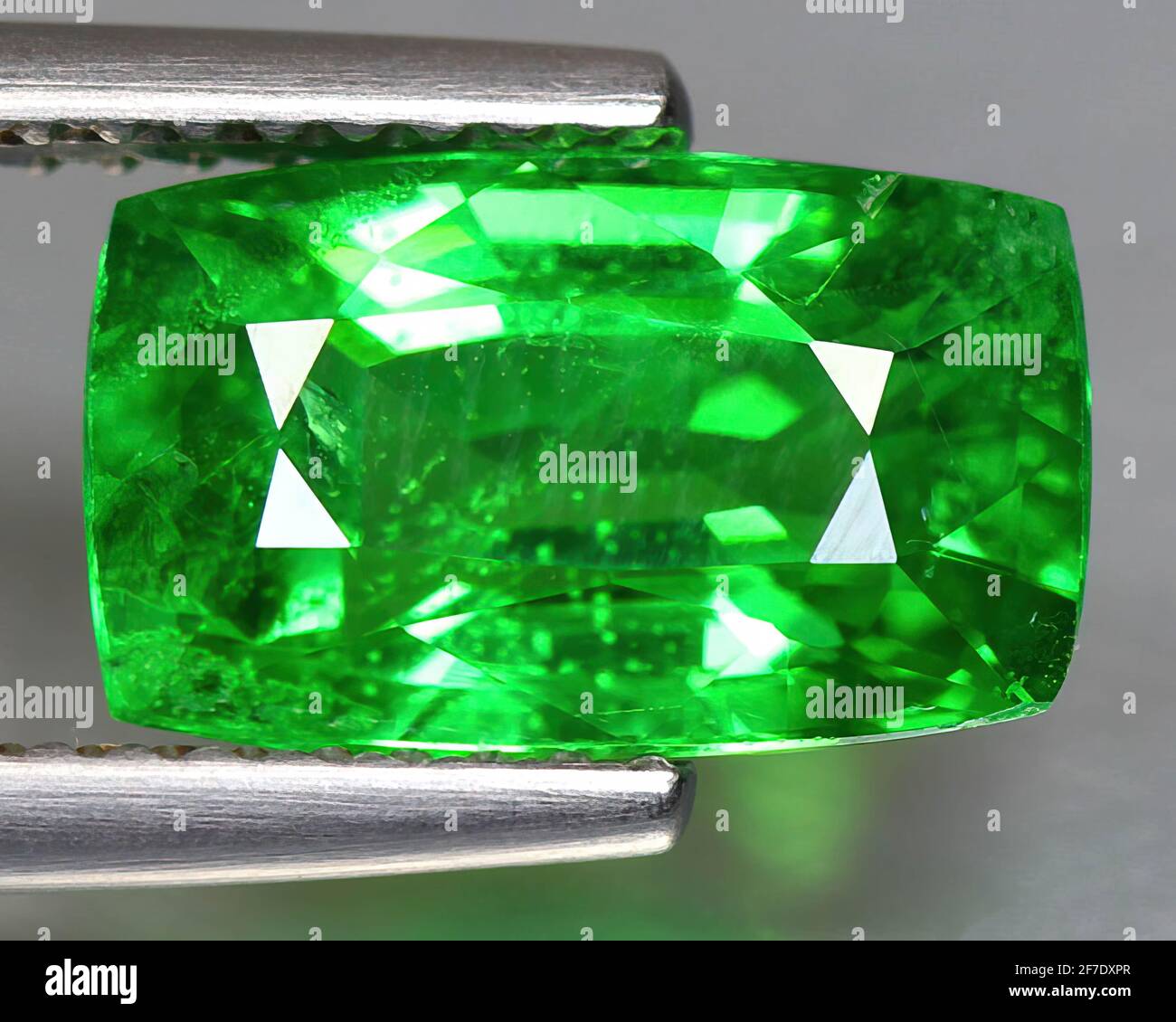 Natural gemstone green tsavorite garnet on background Stock Photo