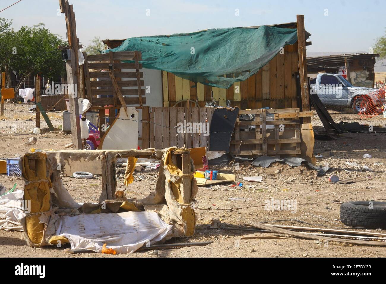House with cardboard and wood next to the remains of an old shattered and  abandoned armchair in a popular neighborhood or poor neighborhood in the  north of Hermosillo, Sonora, Mexico (Photo by