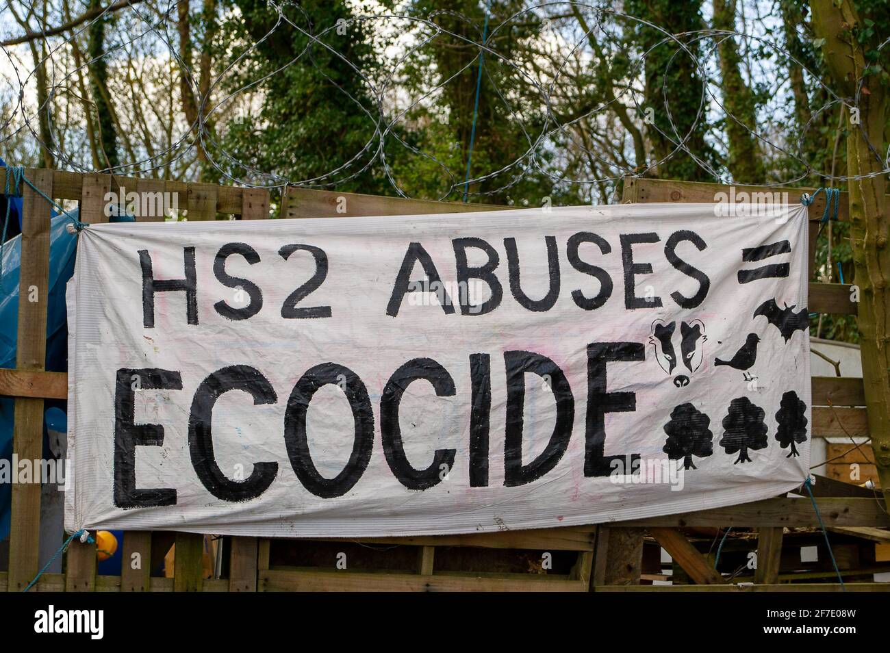 Aylesbury Vale, UK. 6th April, 2021. An HS2 Abuses = Ecocide banner outside the W.A.R Against HS2 camp. Locals and environmentalists are furious about the devestation HS2 is causing to the Chilterns which is an AONB. The High Speed 2 railway from London to Birmingham is having a huge detrimental impact upon wildlife and the environment. Credit: Maureen McLean/Alamy Stock Photo
