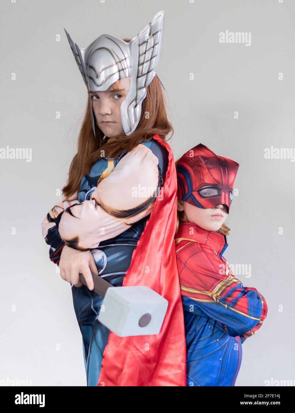 Sister Supper hero'swith red hair dressed as Thor and Captain Marvel