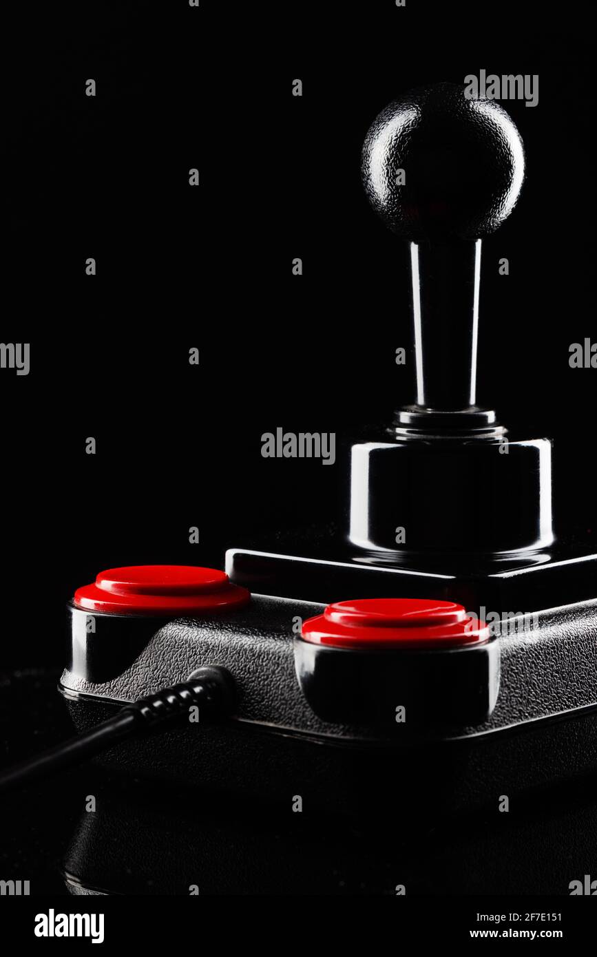 Retro joystick from 8-bit consoles. Game controller isolated on black background Stock Photo