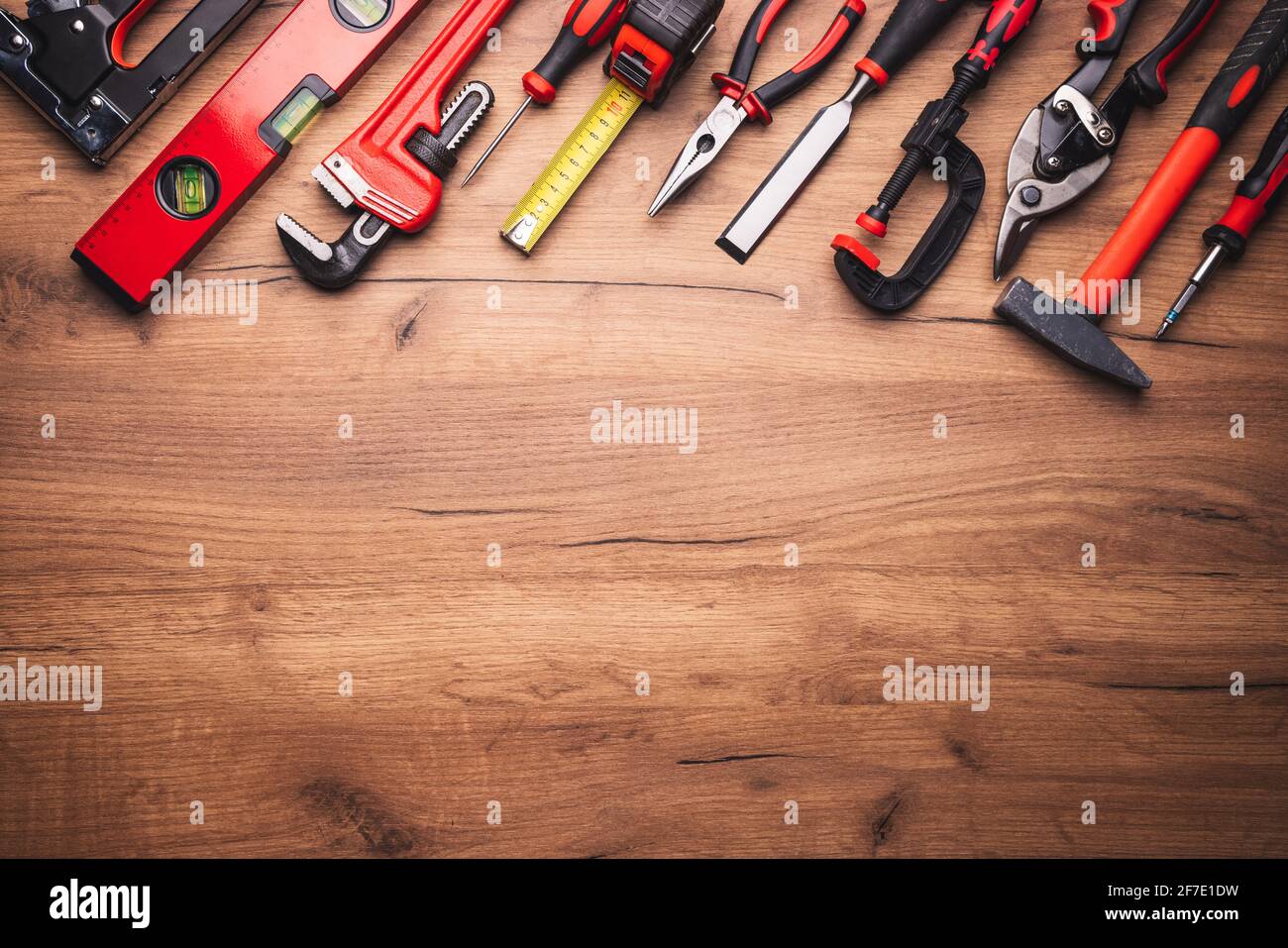 Assorted work tools on wooden background Stock Photo