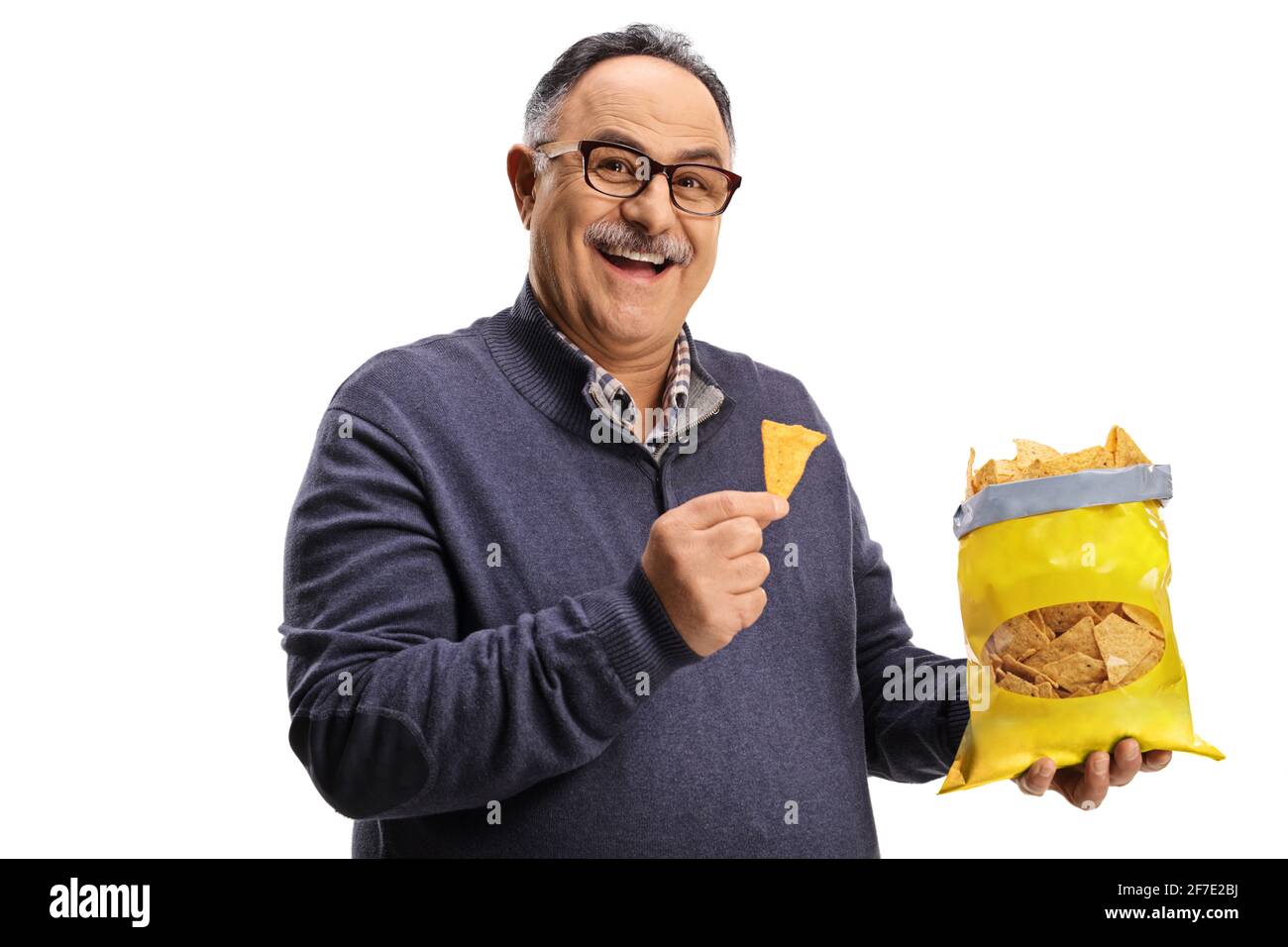 Cheerful mature man holding a pack of tortilla chips isolated on white background Stock Photo