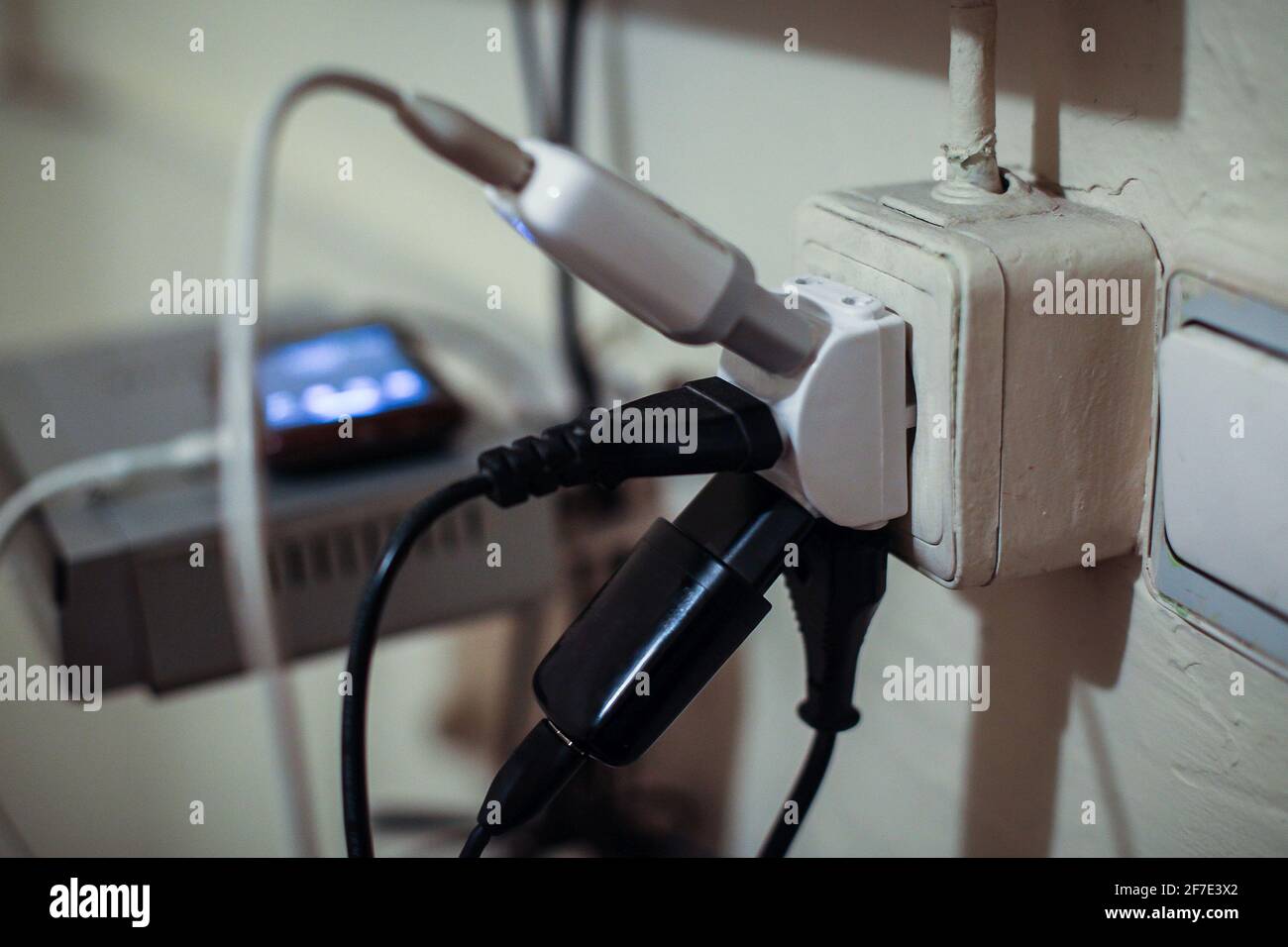 Multiple cables and chargers in one socket or power outlet on the wall