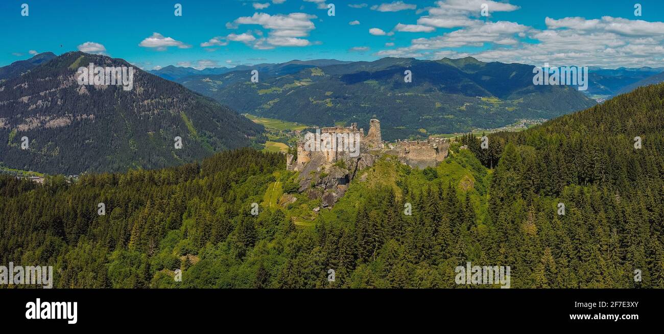 Aerial drone panorama of Steinschloss castle ruins rising above the mura valley in styria, Austria. Medieval ruins in Austria on a sunny day. Stock Photo