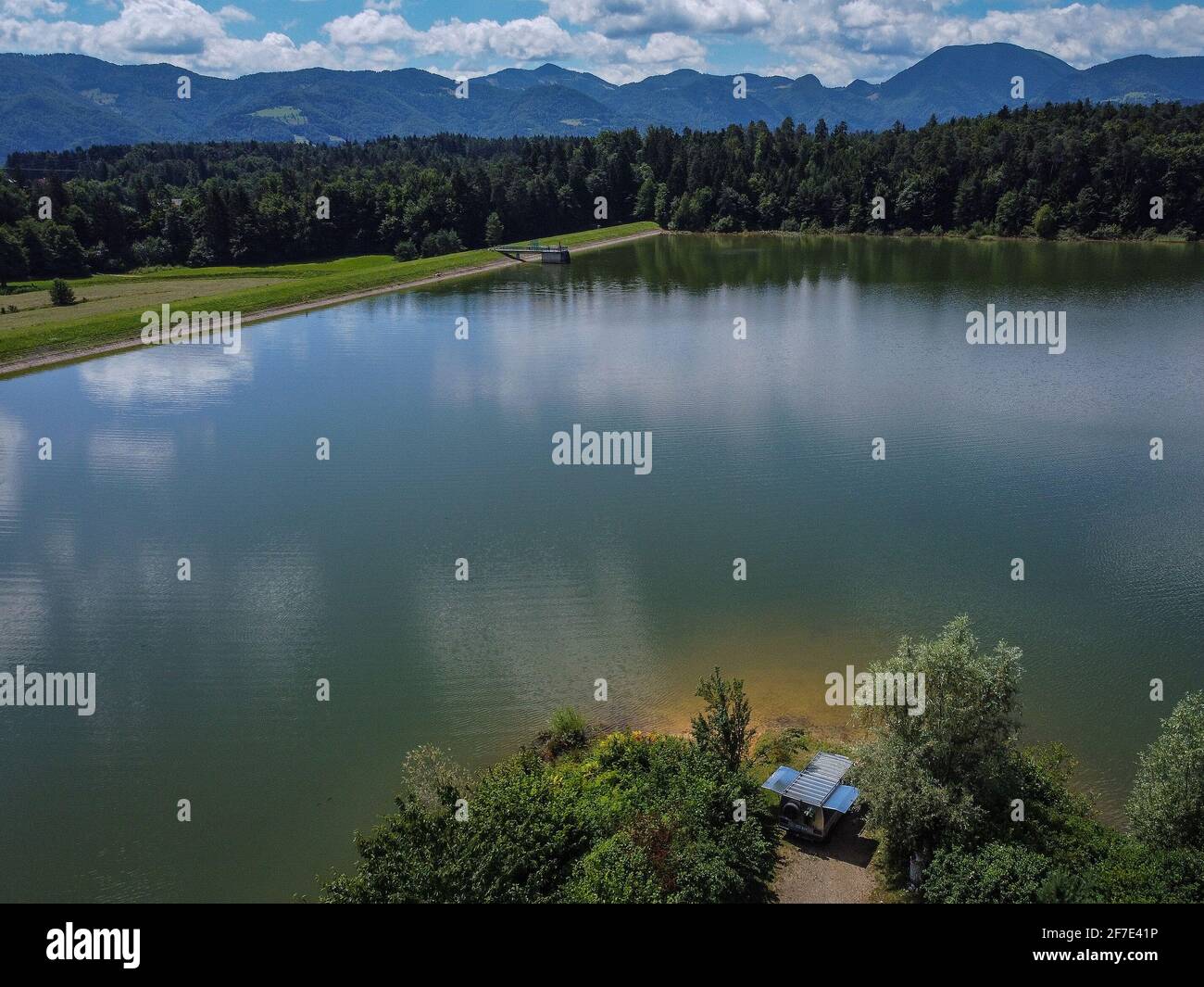 Panorama of Zovnesko jezero or Zovnek lake in Slovenia, on a hot summer  day. Visible parked adventure camper van on the peninsula of the coast  Stock Photo - Alamy