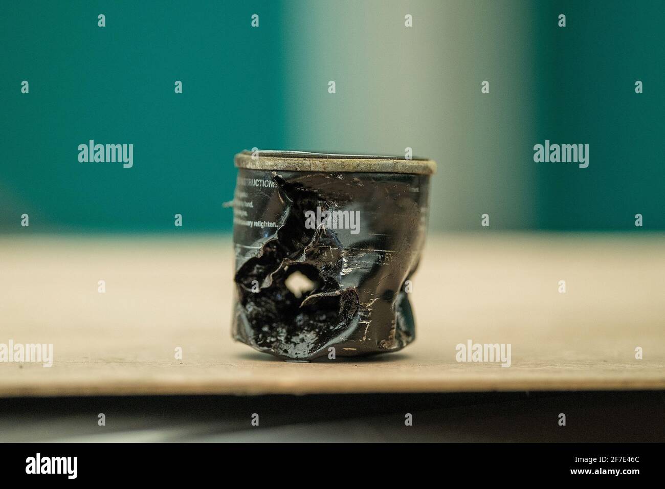 Destroyed old oil filter cartridge due to overtightening. Black oil