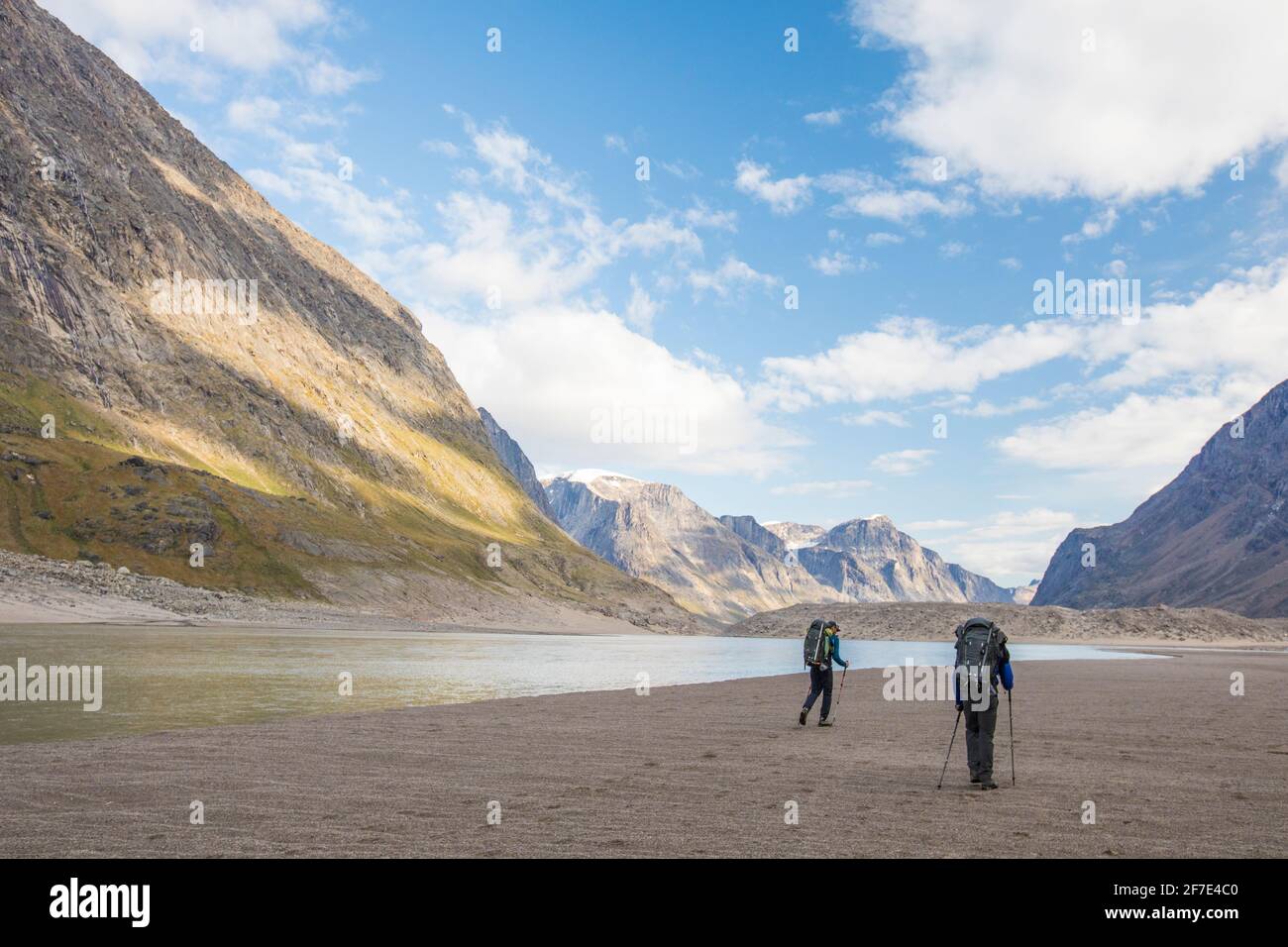 Rear view of two men hiking in Akshayak Pass, Auyuittuq National Park Stock Photo