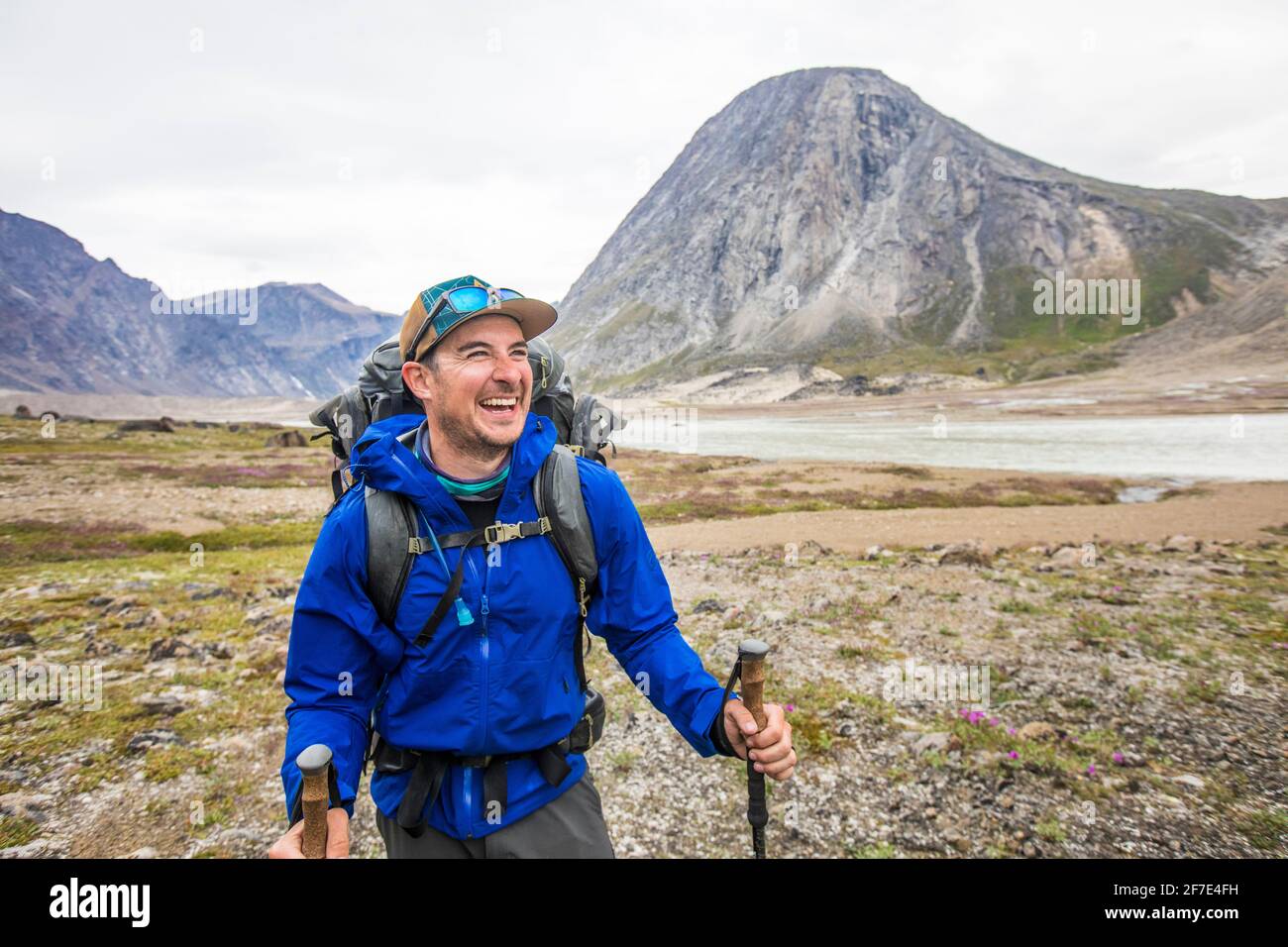 Portrait of happy mountaineer in Akshayuk Pass, Baffin Island, Canada Stock Photo