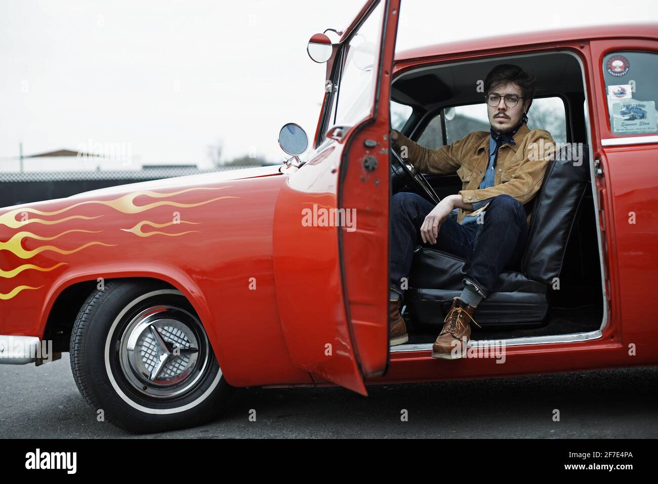 GREAT BRITAIN / England / Young man sitting in 1954 Ford at the Hot Rod Night , Ace Cafe London. Stock Photo