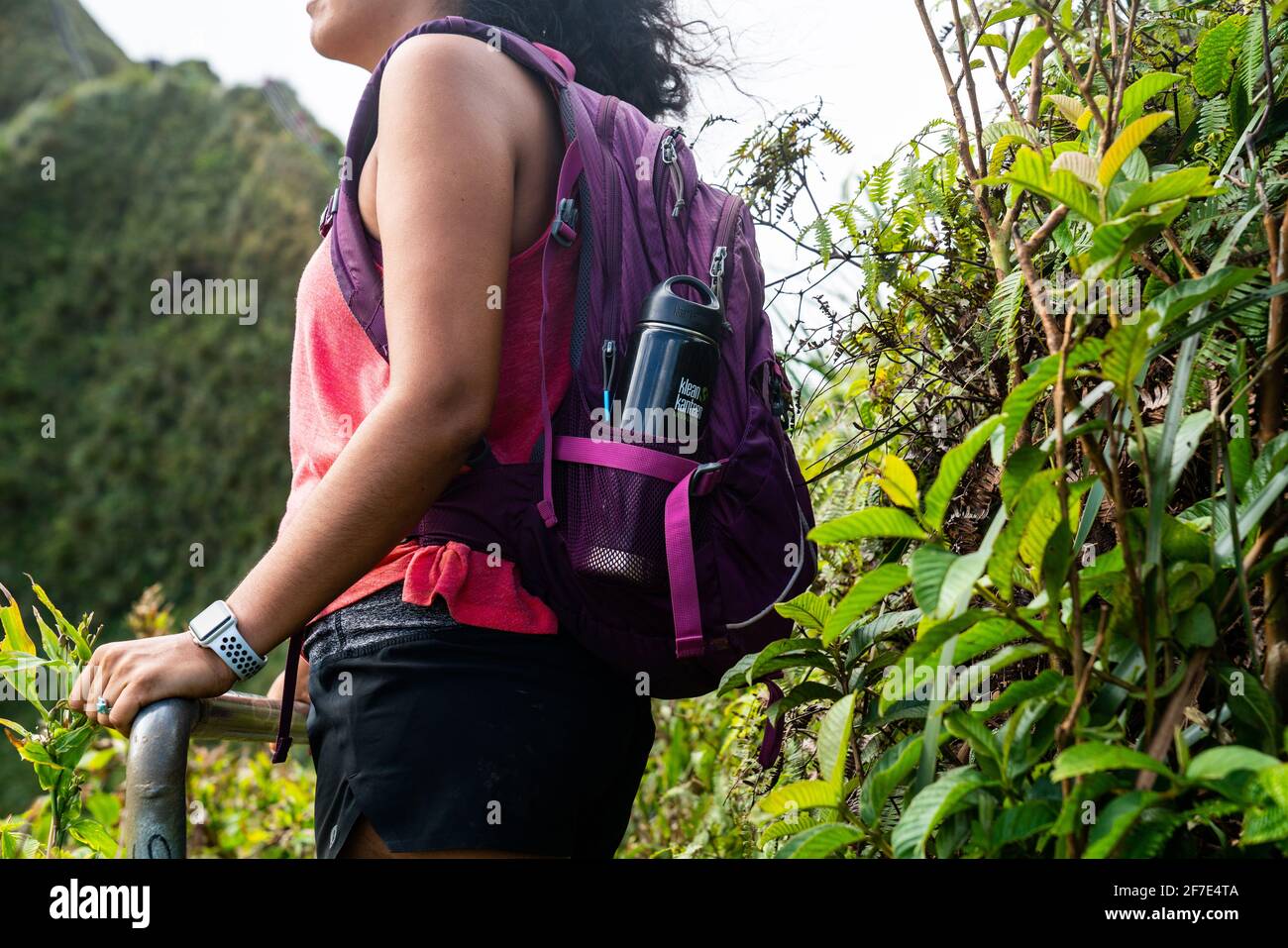 Woman embracing the beauty of her surroundings as she hikes in Hawaii Stock Photo