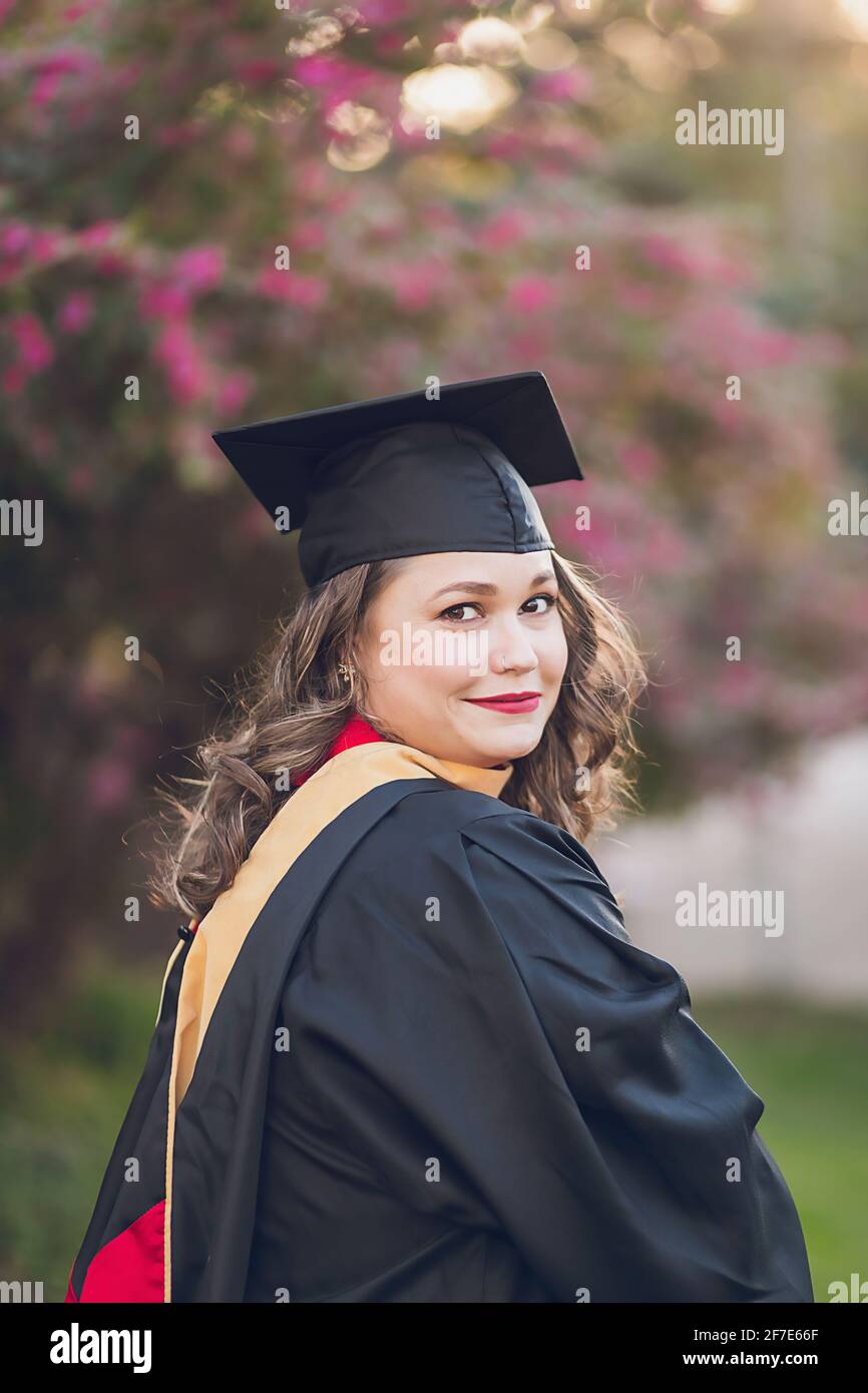 Woman wearing a graduation gown/cap. Stock Photo