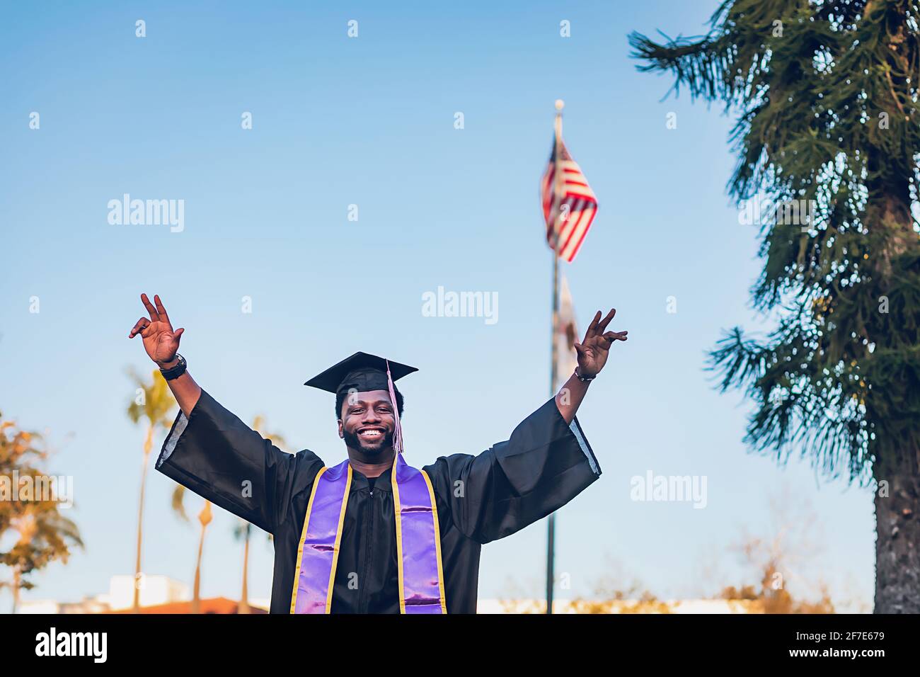 Young man with graduation cap and gown and diploma Stock Photo - Alamy