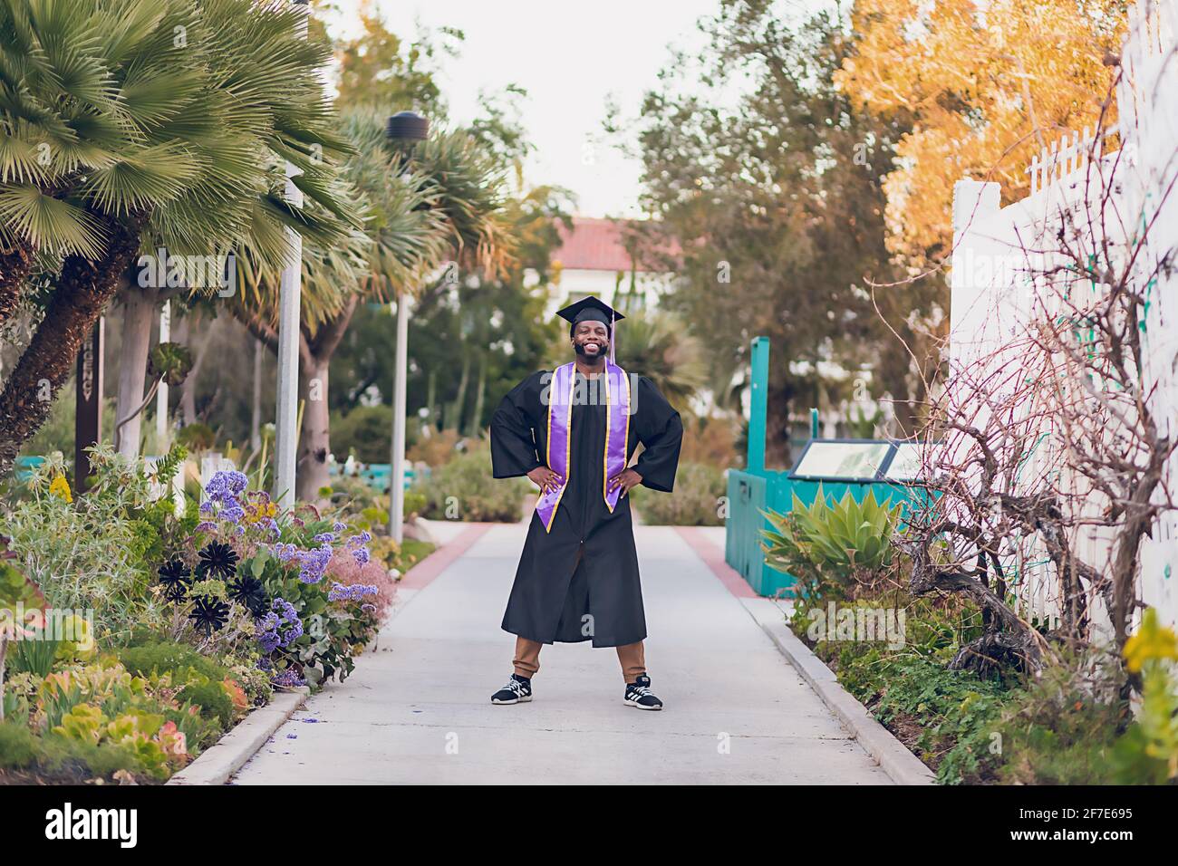 Young man graduating college, wearing a graduation gown/cap. Stock Photo