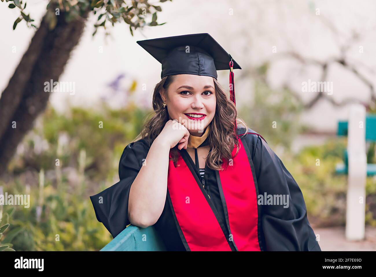 Young woman wearing a graduation gown/cap Stock Photo - Alamy