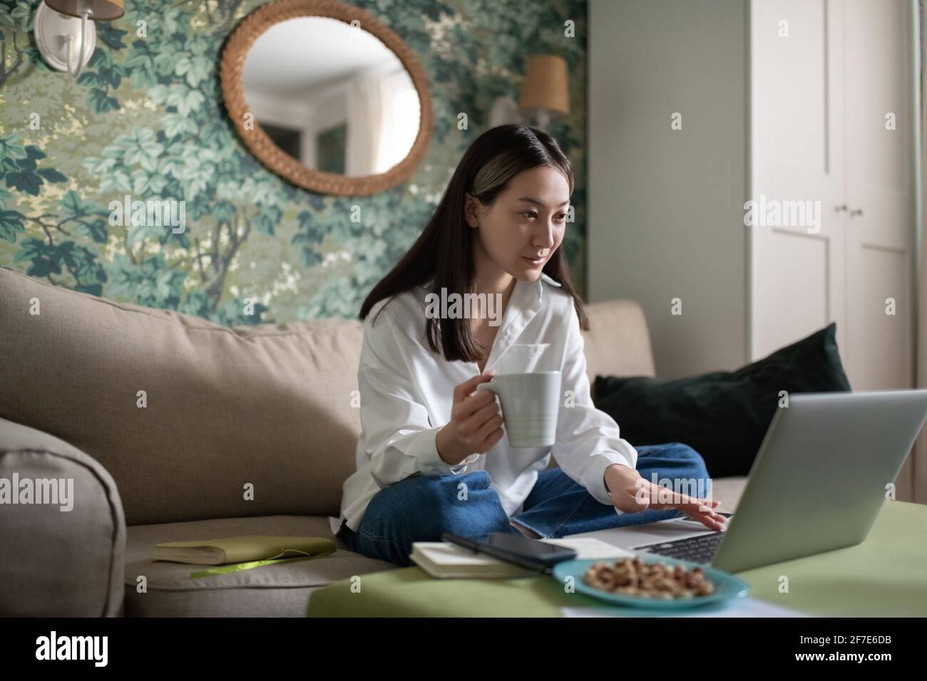 Asian woman preparing for online meeting at home Stock Photo