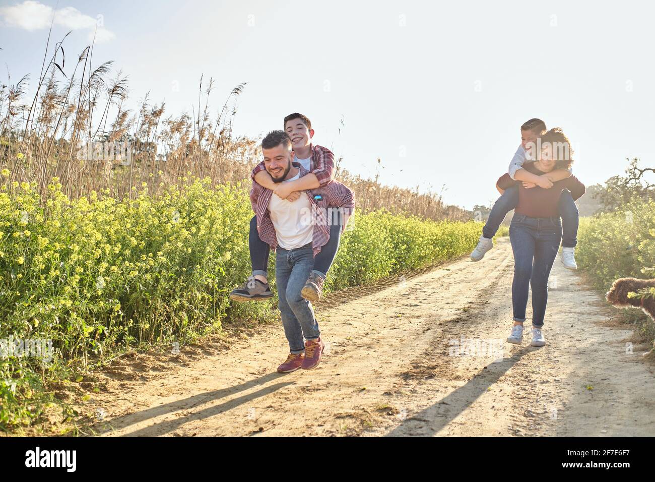 happy family runs through the countryside in spring Stock Photo