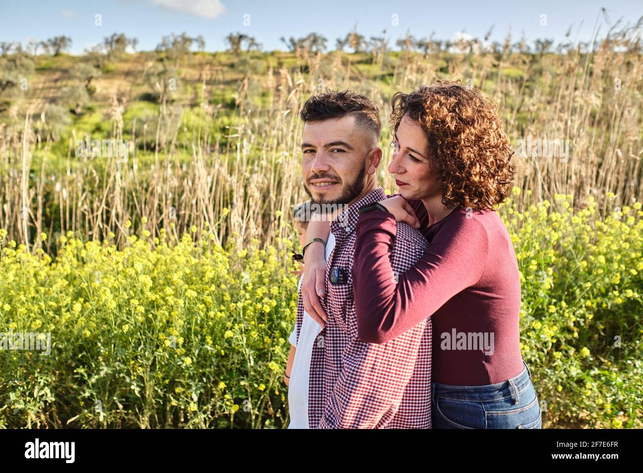 portrait of happy couple in the countryside, he looks at the camera Stock Photo