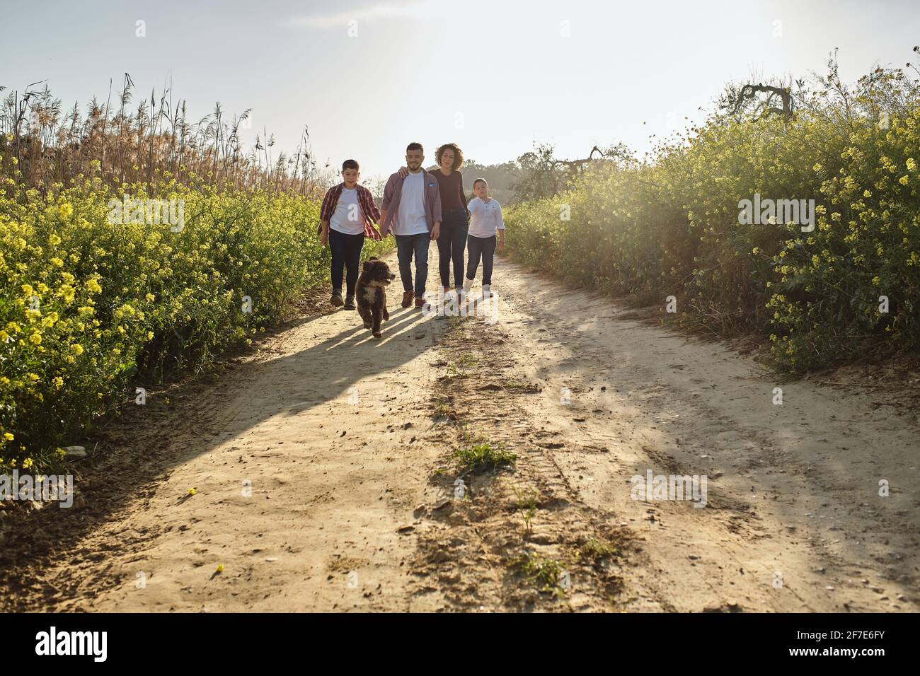 happy family walking in the countryside with their pet Stock Photo