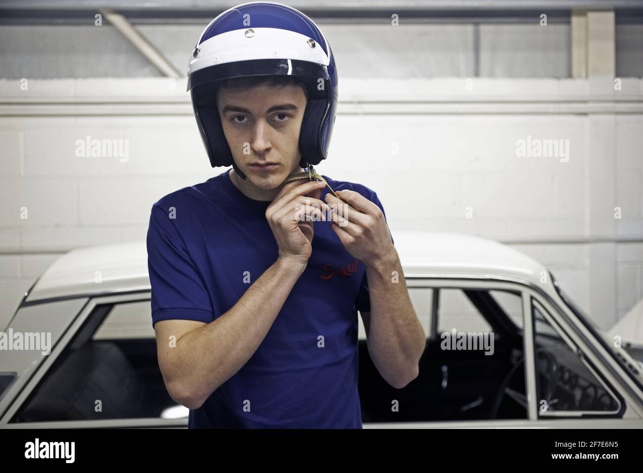 Racer getting ready wearing a helmet before racing . Stock Photo