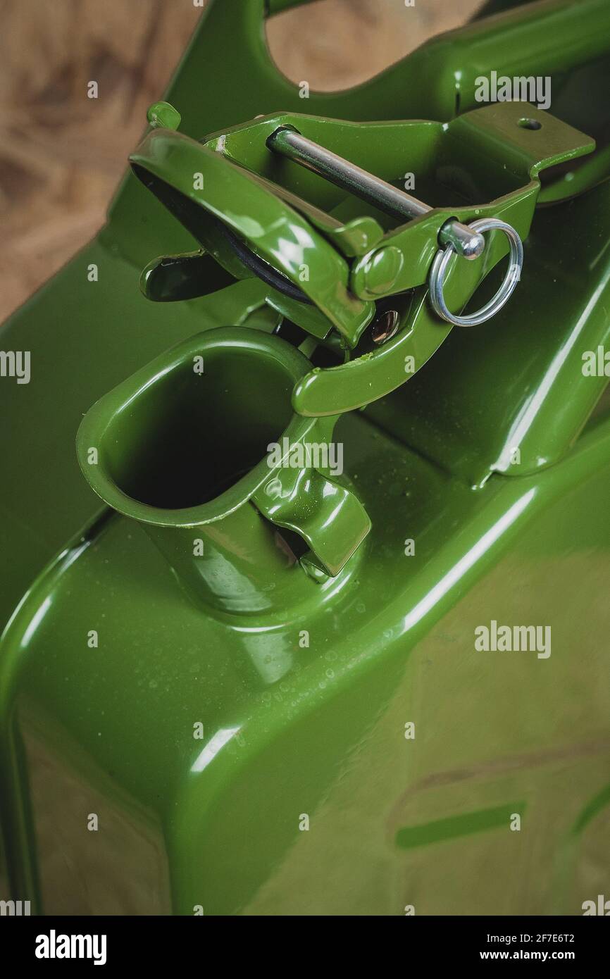 Opening of a green metal jerry can. Lid or cap of a jerry can is opened