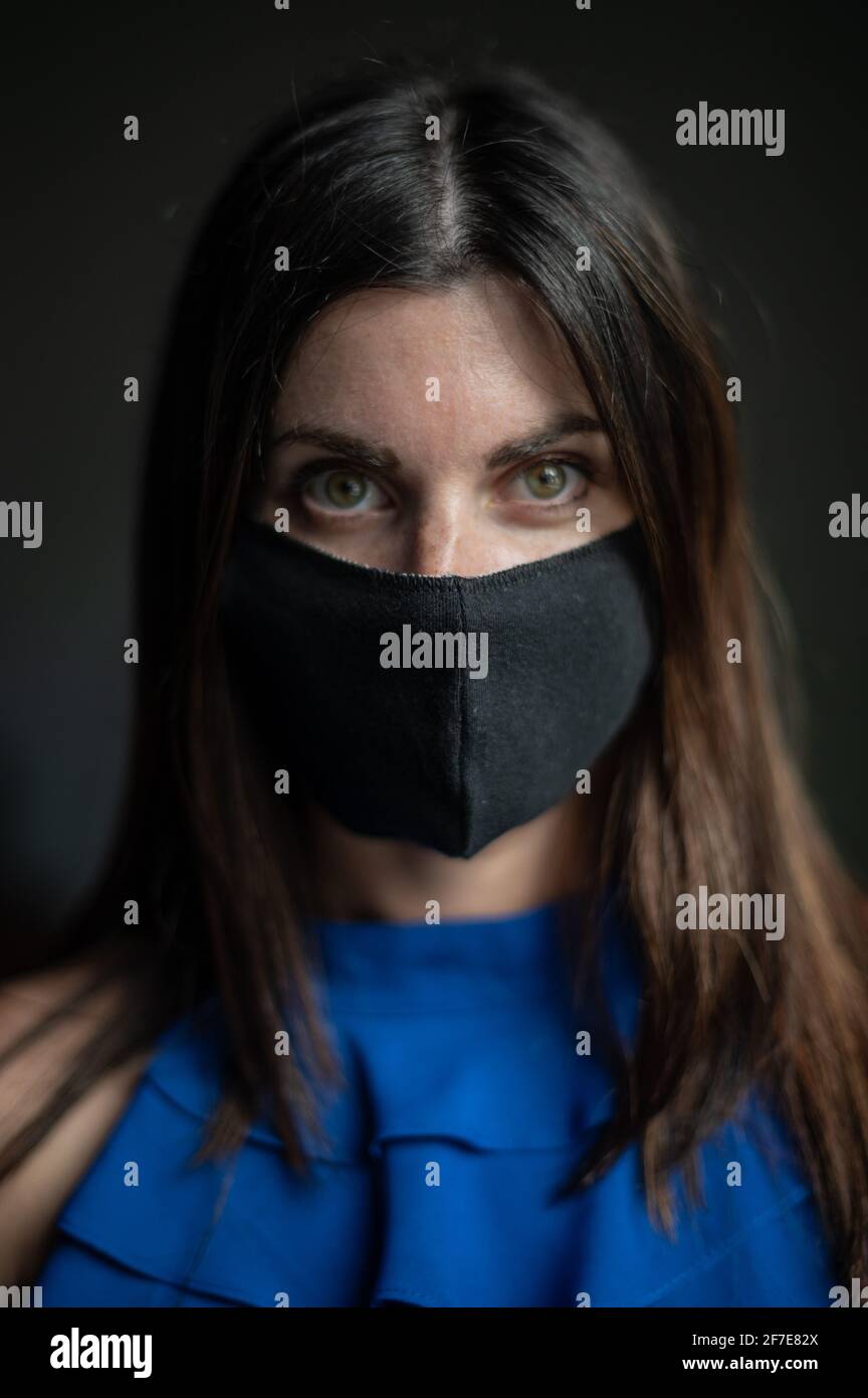 Interior portrait of an attractive caucasian woman wearing a face mask Stock Photo
