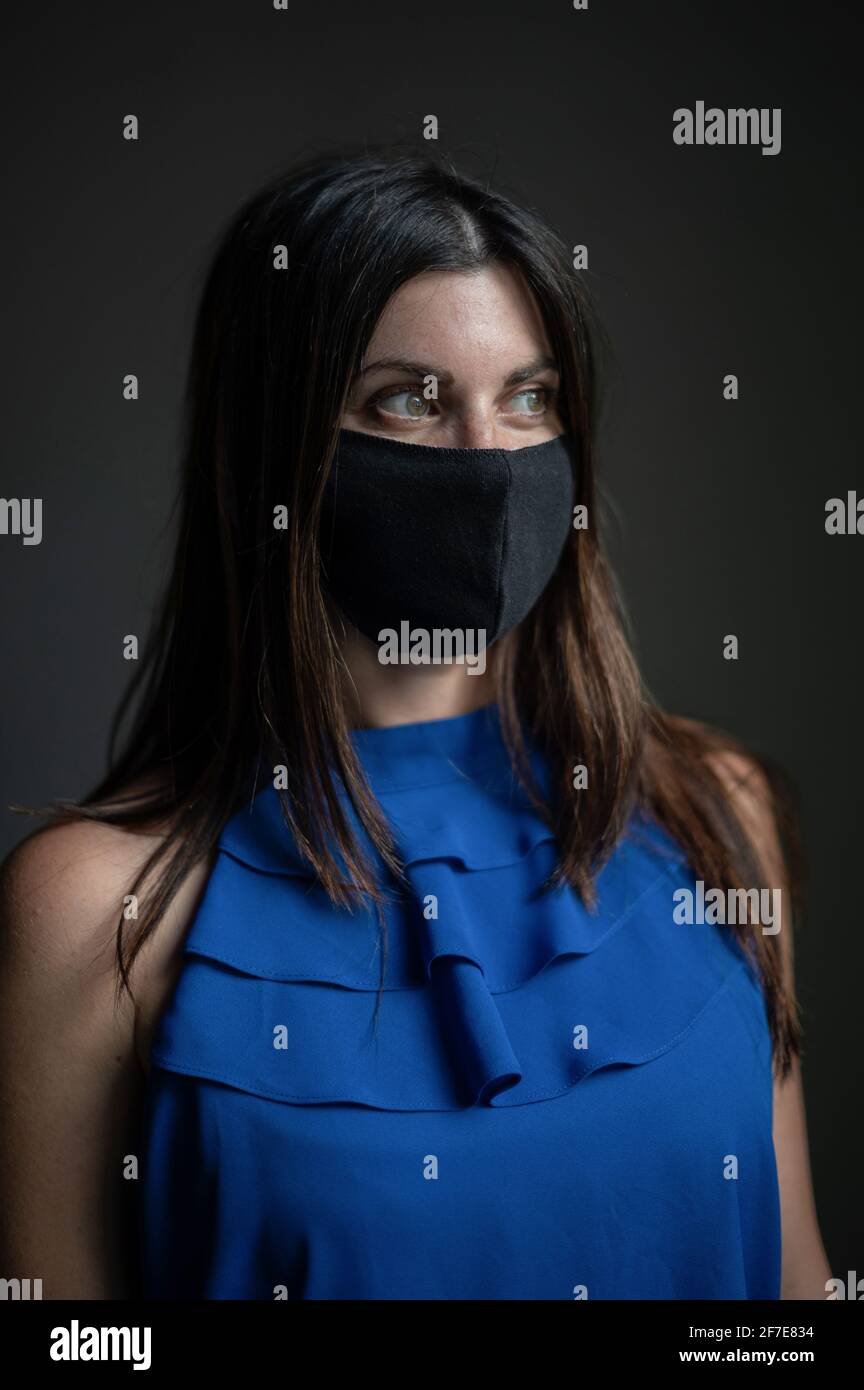 Interior portrait of an attractive caucasian woman wearing a face mask Stock Photo