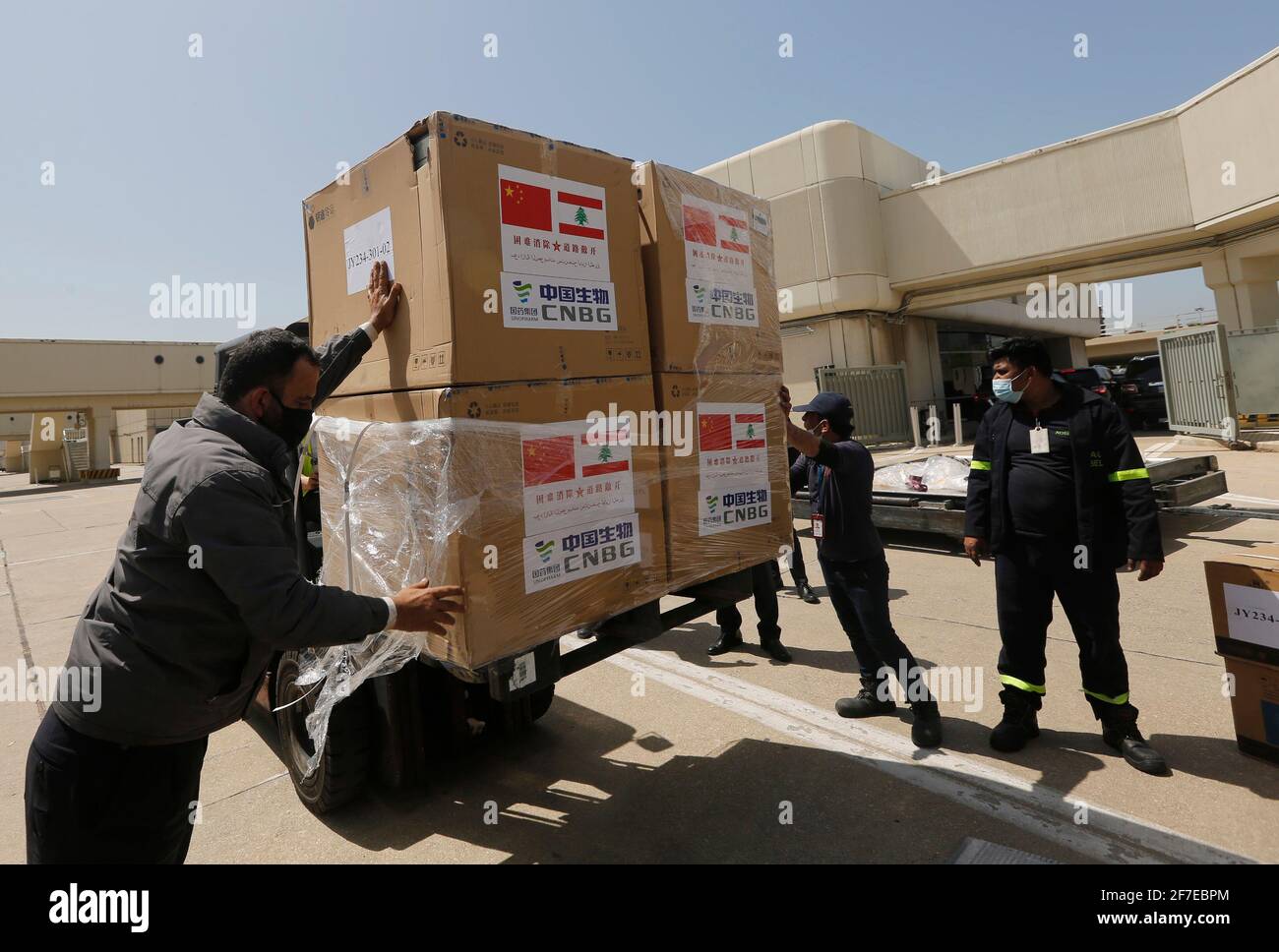 Beirut, Lebanon. 6th Apr, 2021. Staff transport the Sinopharm vaccines donated by China at the Rafic Hariri International Airport in Beirut, Lebanon, April 6, 2021. Two batches of Sinopharm vaccines donated by China arrived in Lebanon on Tuesday. Credit: Bilal Jawich/Xinhua/Alamy Live News Stock Photo