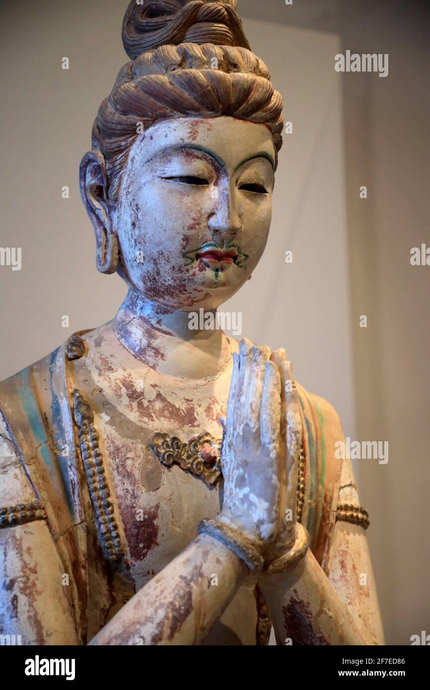 Kneeling Attendant Bodhisattva statue from Chinese Tang Dynasty display in Arthur M.Sackler Museum.Harvard University.Cambridge.Massachusetts.USA Stock Photo