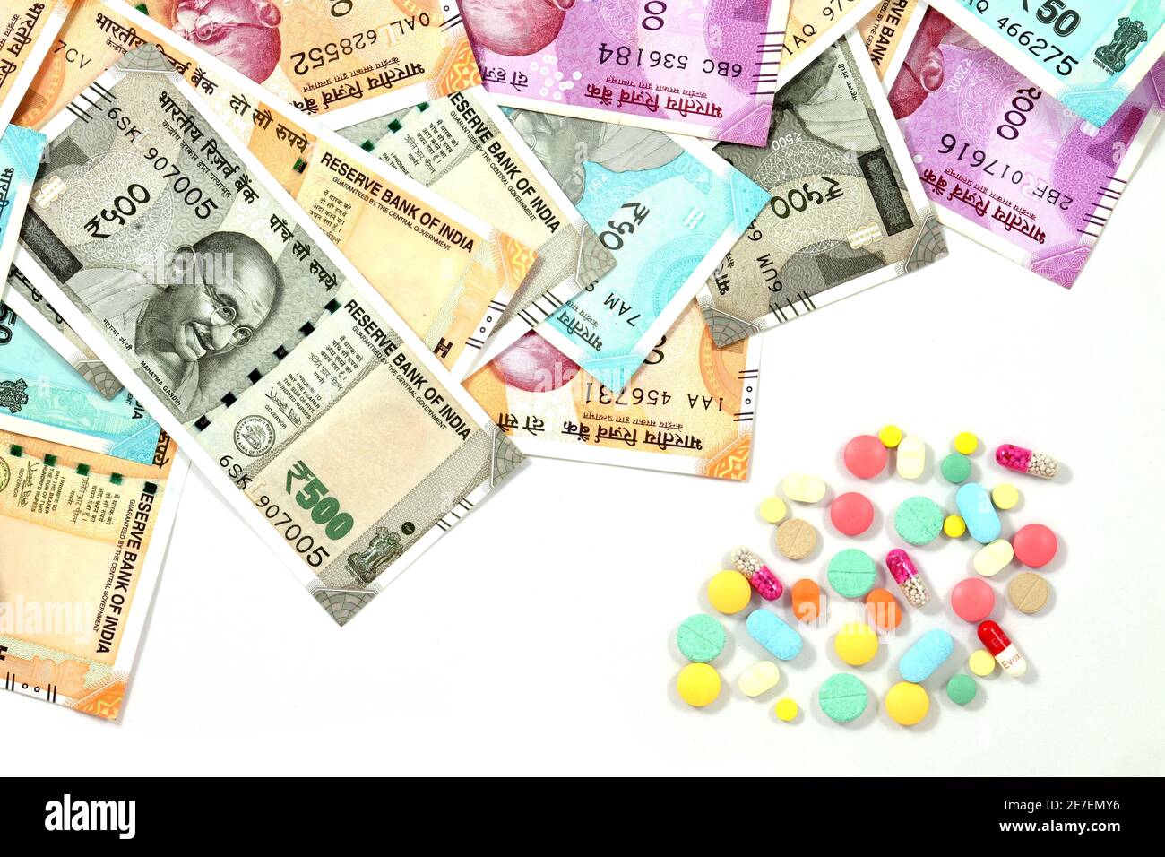 Pile of pharmaceutical drug, medicine pills and indian money, cost of healthcare and medical insurance concept Stock Photo