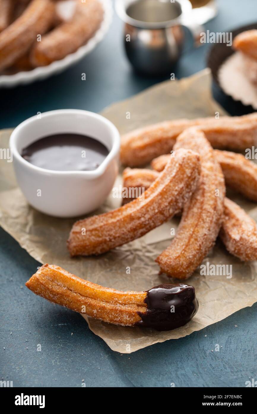 Homemade churros with cinnamon sugar on parchment Stock Photo