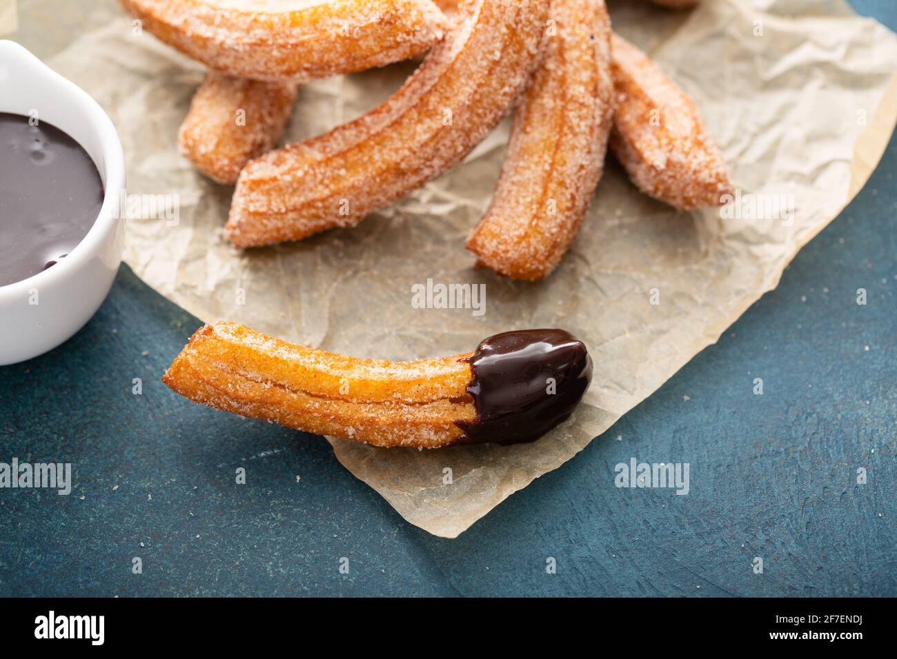 Homemade churros with cinnamon sugar on parchment Stock Photo