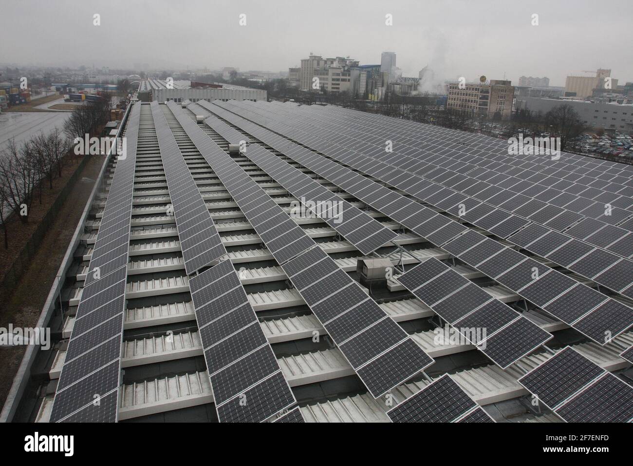 Solar panels installed on a roof of a large industrial building or a