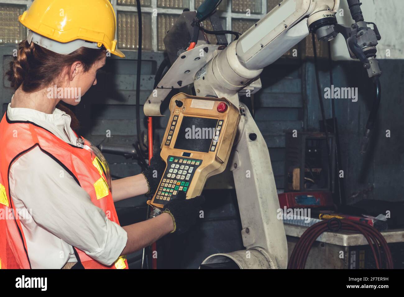 Smart factory job worker control robotic arm in manufacturing . Industry and